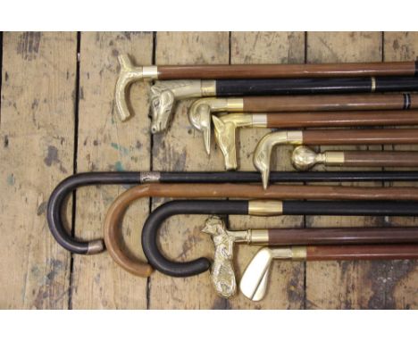 A collection of thirteen assorted walking sticks, to include; a bog oak example, a Victorian example with silver collar, a ca