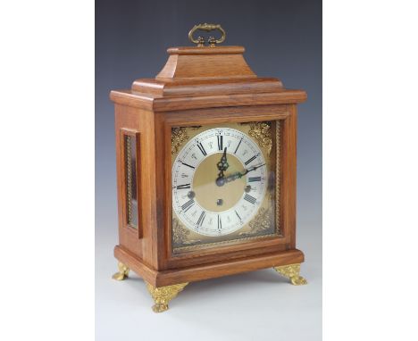 A German eight day mantel clock, silvered Roman numeral chapter ring and F. H. S movement striking on eight gongs, in oak cas