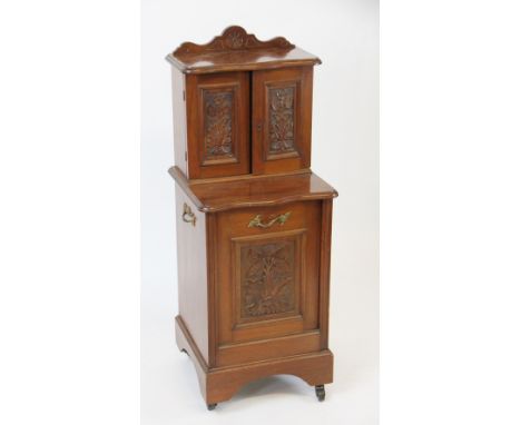 A late Victorian carved walnut purdonium, with two cupboard doors above coal drawer, on bracket feet, with casters, 100cm H x