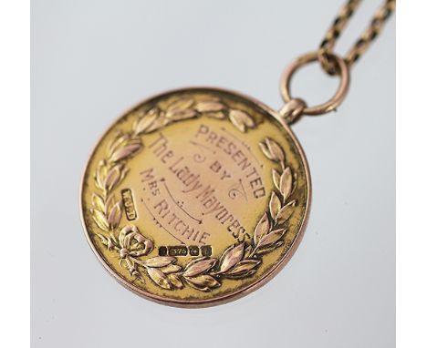 A 9ct yellow gold swimming medallion dated 1919, with an attached chain (unmarked), total weight 22.5gms 