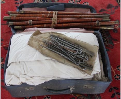 A vintage white canvas tent, with brass mounted bamboo poles, by repute used by the Rover Scouts of Southall, west London, in