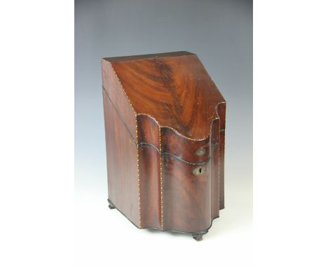 A George III mahogany serpentine cutlery box, with chequer banding, and original fitted interior, the underside of the lid wi