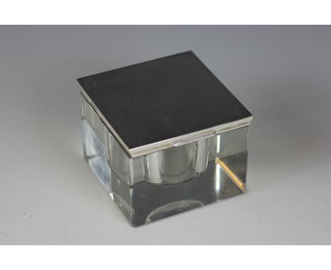 A silver topped inkwell, Adie Brothers, Birmingham 1948, the plain glass cube inkwell with engine turned silver cover, 6cm hi