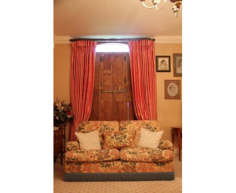 A pair of peach silk country house curtains, fully lined and interlined, each curtain 278cm drop, 262cm wide, with tie backs