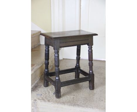 An oak joint stool, the underside of the lid with engraved brass presentation plaque, 'Made from an oak found at the wall, fo