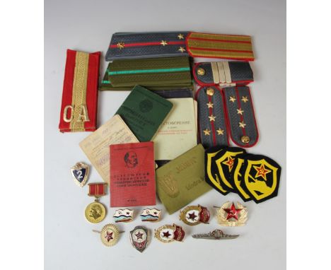An assortment of Russian Military ephemera including epaulettes, passports, buttons and badges (Qty)