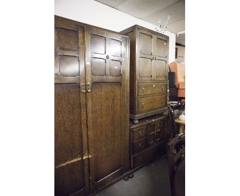 AN OAK THREE PIECE BEDROOM SUITE, COMPRISING; A TALLBOY, A DRESSING TABLE, WITH SHAPED MIRROR OVER SOLID BASE WITH CENTRAL CU