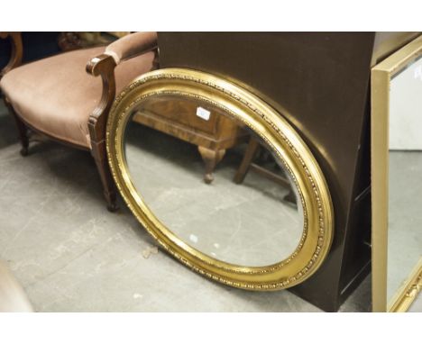 AN OVAL BEVELLED EDGE WALL MIRROR, IN GILT CAVETTO FRAME 