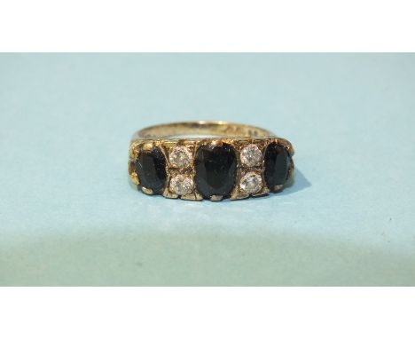 A 9ct gold ring set three oval sapphires and two pairs of brilliant-cut diamonds, size M, 4g.