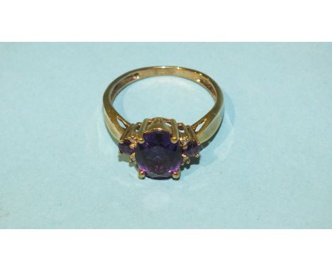 A 9ct gold ring set amethysts and diamond points, size Q, 2.9g.