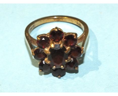 A garnet cluster ring claw-set nine garnets, in 9ct gold mount, size O, 4.1g.