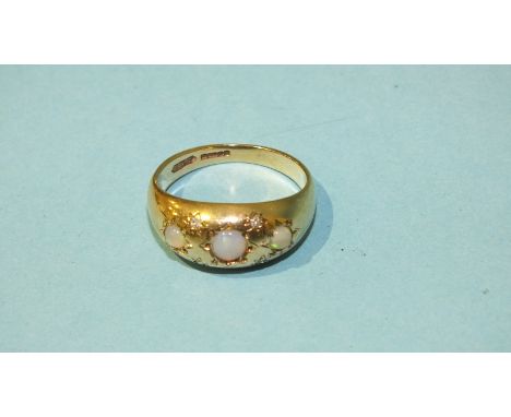 A 9ct gold gypsy ring set three opals and four diamond points, size K, 2.8g.