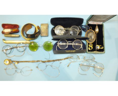 A collection of vintage spectacles, a yellow metal watch chain and compass fob and other items.