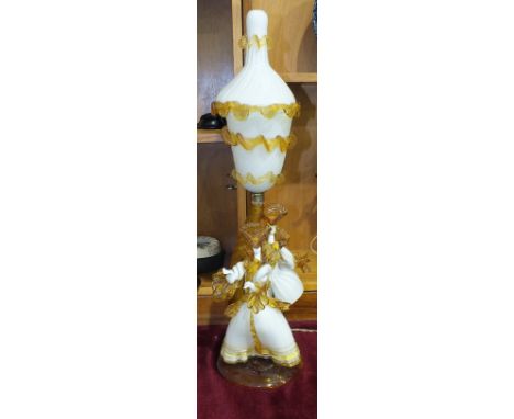 A Murano white and amber glass lamp in the form of two dancing figures, with inverted bell shape shade and cover, 65cm high, 