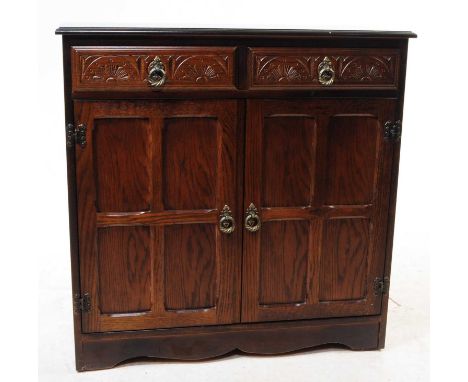 Manner of Ercol Furniture- A 20th century oak sideboard bookcase display cabinet in the manner of Ercol Old Colonnial pattern
