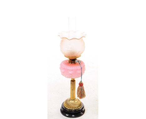 A 19th century Victorian oil lamp. The lamp featuring a pink reservoir with floral detail. Having a frosted rose glass presse