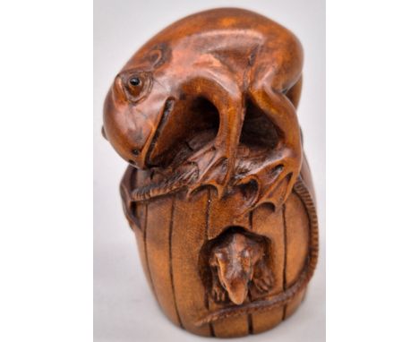 Japanese hand carved boxwood netsuke of a Frog and mouse on a barrel. Both fitted with black bead eyes. Signed to the base. [