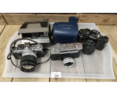 A tray of vintage cameras; Yashica H 101157 Minister- D, Olympus OM-2, Canon A-1 and two Polaroid instant cameras 