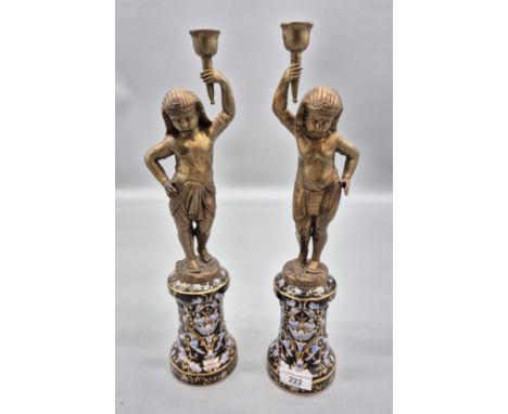 A Pair of Reproduction ancient Egyptian figural candle sticks fitted on ceramic bases, Bronze/ brass figures [38cm high] 