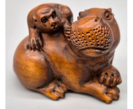 Japanese hand carved boxwood netsuke of a Hippo and monkey. Both having black bead eyes and signed. [5cm in length] 