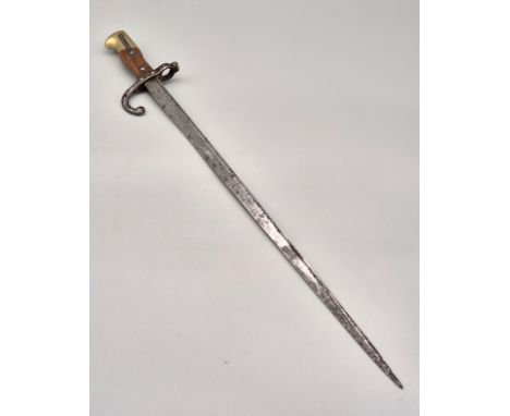 1881 French Bayonet. Showing various markings and engraved to the side of the blade. Brass and wood handle, push button works