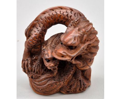 Japanese hand carved boxwood netsuke of two dragons. Both having black bead eyes. Signed to the base. [4.5cm high] 