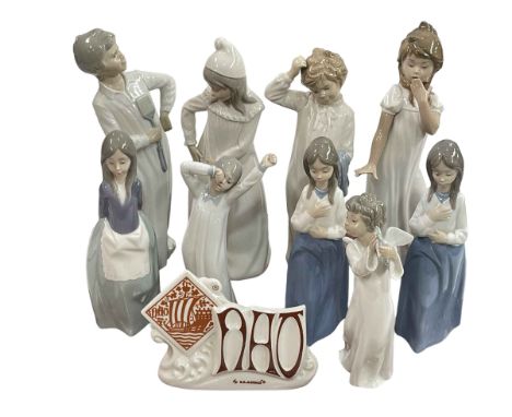 Nine Nao figures and advert sign including Boy with Fly Swatter, Girl with Torn Nightgown and Girl Yawning.