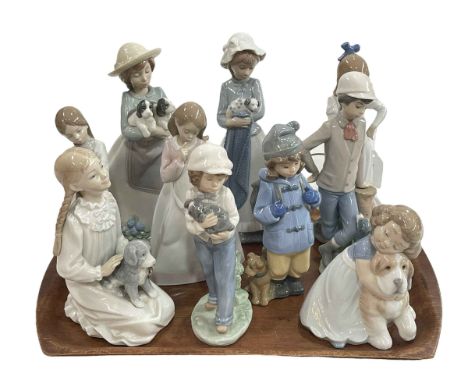 Ten Nao figures, all with or holding dogs.