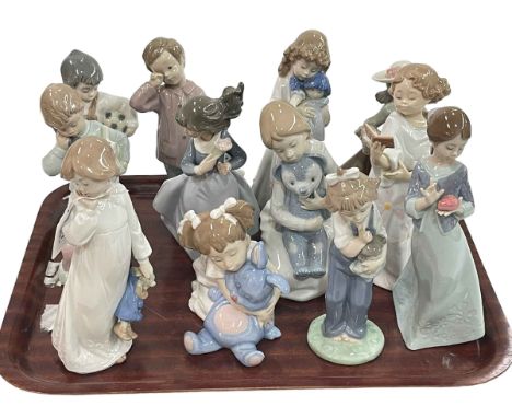 Twelve Nao figures including seven holding soft toys.