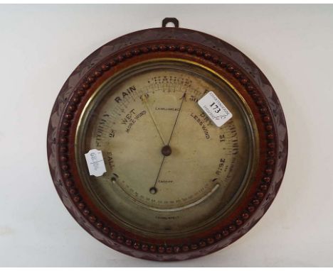 An E A Williams & Co aneroid barometer and thermometer, 30 cm wide, the Queen's Award to Industry 1969, six portrait miniatur