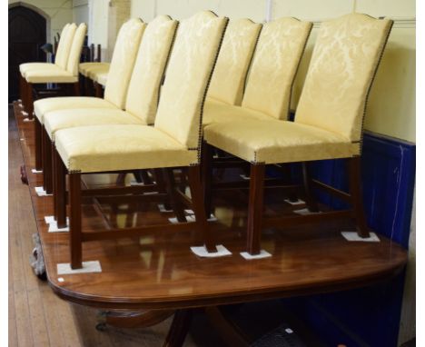 A large Regency style mahogany three pillar dining table, inset two extra leaves, 630 cm (20 ft 8 inches), and a set of twent