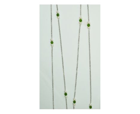 A silver, peridot and pearl long guard chain