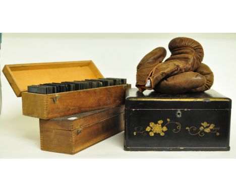 A pair of early 20th century leather boxing gloves, two boxes of late 19th/early 20th century glass photographic slides, a Ja