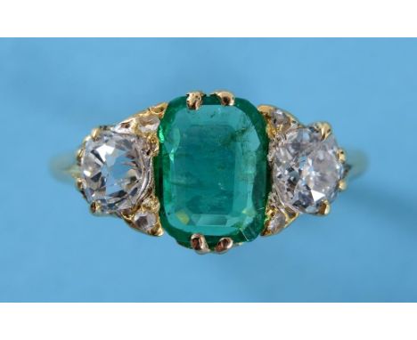 A large emerald and diamond ring, the 1.70ct Colombian natural cushion cut emerald flanked by old brilliant cut stones, in a 