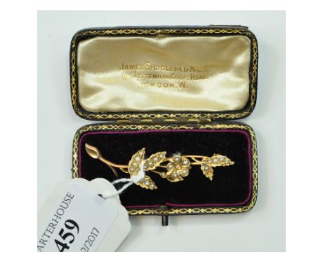 A yellow coloured metal and seed pearl floral spray brooch, in a James Shoolbred & Co box (lacks one seed pearl)