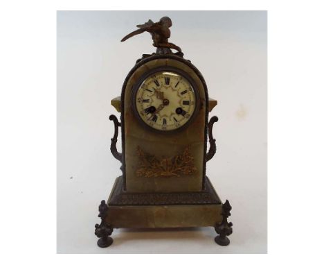 A mantle clock, the painted dial with Roman numerals, fitted a movement striking on a gong, in an onyx case, applied a bronze