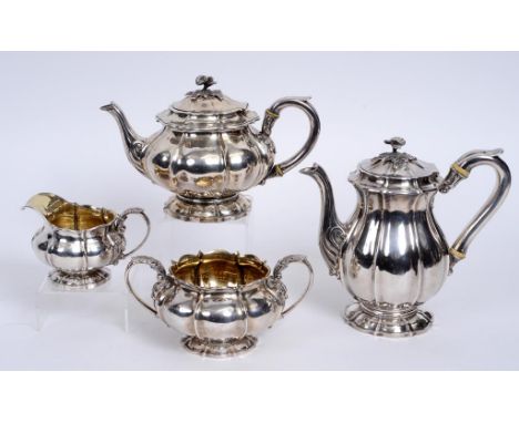 A George IV silver three piece service, comprising a hot water jug, 21 cm high, a sugar bowl, and a milk jug, Richard Sibley 