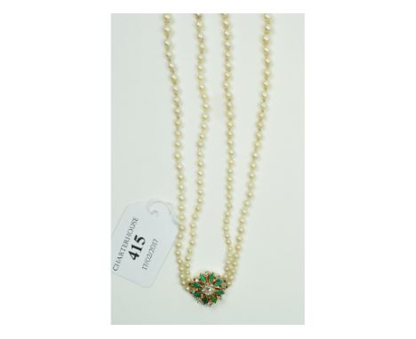 A two strand graduated pearl necklace, with a diamond and turquoise flowerhead clasp