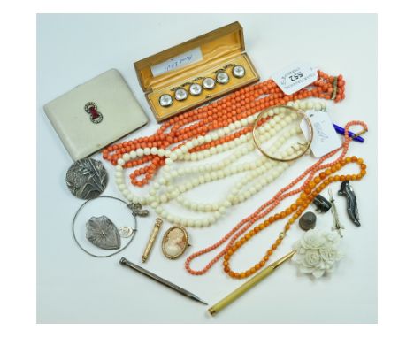 A 9ct gold bangle, a three strand coral necklace, a propelling pencil and other items