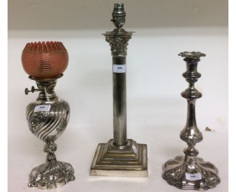 A silver plated Corinthian column table lamp, 44 cm high, a plated candlestick, and a plated oil lamp (fitted for electricity