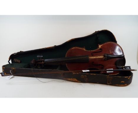 A Czechoslovakian violin, with a bow, and a case (distressed)