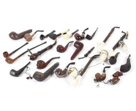 A collection of 20th century pipes. Including wooden and ceramic examples, one having a silver mount in original leather case
