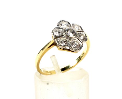 A vintage 18ct gold and diamond flower-head cluster ring. The seven round brilliants approx. 1.20cts total, all in white indi