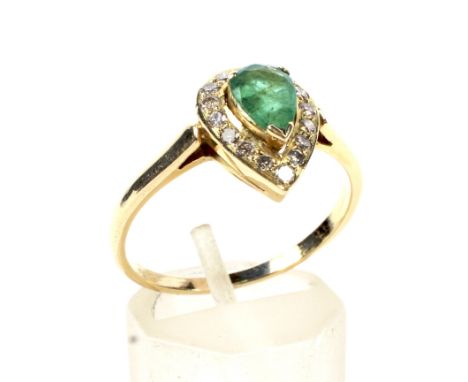 A modern emerald and diamond pear-shaped cluster ring. Centred with a pear-shaped emerald approx. 0.50cts, claw set within a 