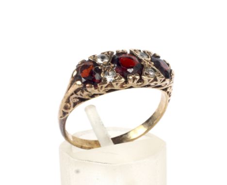 A vintage 9ct gold, garnet and paste half-hoop ring in Victorian style. The three oval mixed-cut garnets spaced by small past