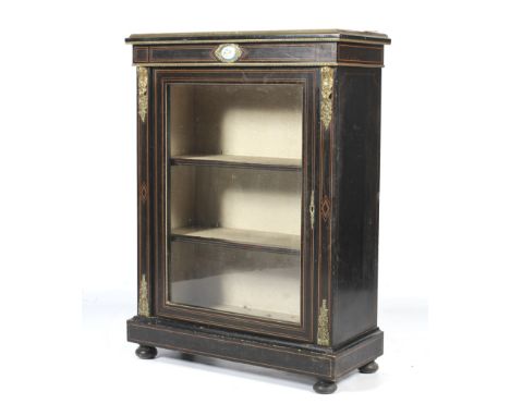 A 19th Century French ebonised gilt-metal mounted pier cabinet. The frame inset with an oval porcelain plaque painted with fl