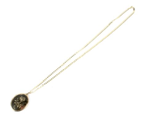 A modern 9ct gold necklace and a locket. The filed-curb link necklace on a bolt ring clasp with post 2000 convention hallmark