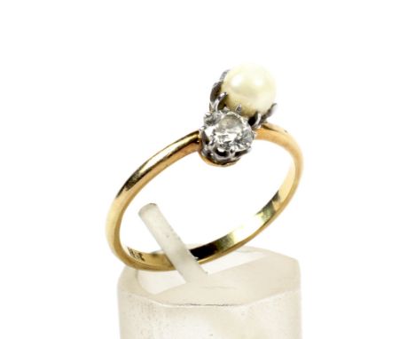 An early 20th century gold, diamond and cultured-pearl two stone ring. The old-cut diamond approx. 0.38cts in an off-set claw