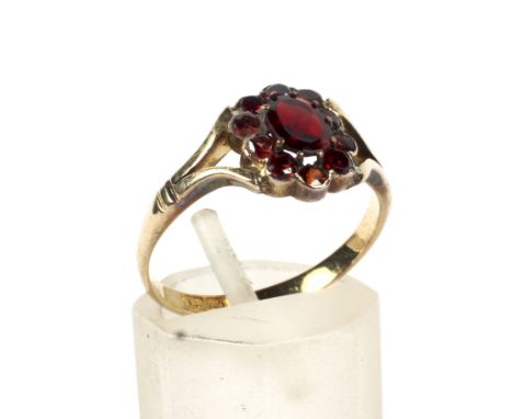 A 19th century gold-plated and red-paste oval cluster later mounted on a gold shank as a ring. The head set with eleven oval 