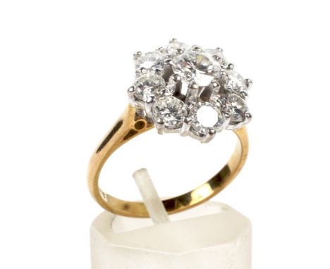 A vintage diamond nine stone cluster ring. Centred with a round brilliant diamond approx. 0.56cts, in a raised claw setting w